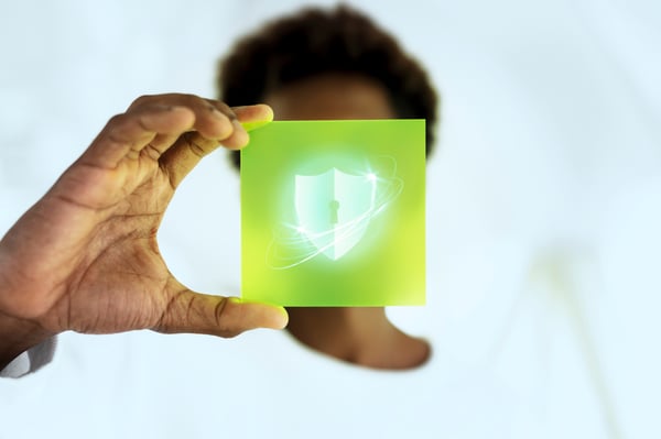 This is an image of a woman holding a cyber security badge.