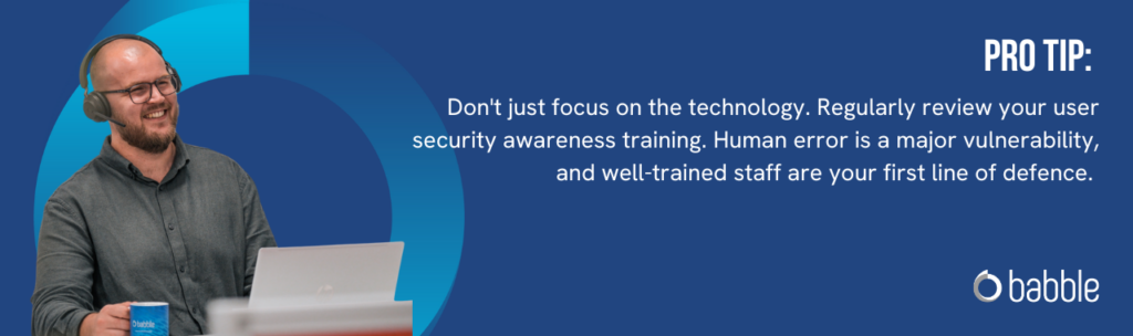 The graphic visually represents a "pro tip" to regularly review your user security awareness training and features an image of a man smiling at his desk with headphones on.