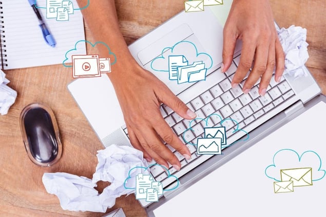 Hands on laptop with emails.