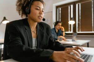 This is image of two call centre agents sitting at their desks.