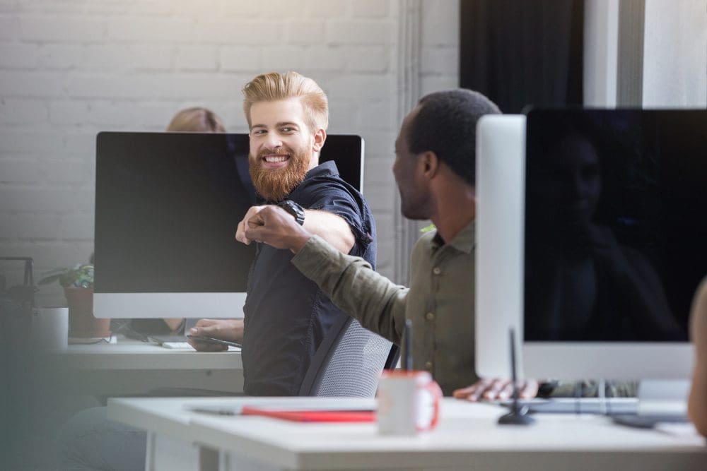 Two young men celebrating at work