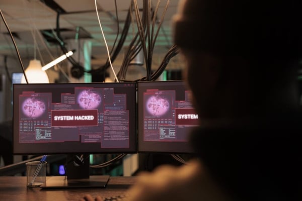 This is an image of monitor screens that have a system hack message