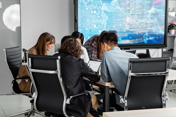 This is an image of people working together in a boardroom 