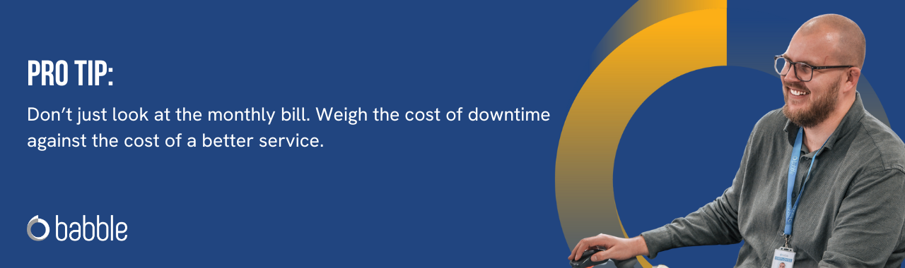 This graphic visually represents a "pro tip" that advises you to weigh the cost of downtime against the cost of a better service and features an image of a man smiling and working at a desk.