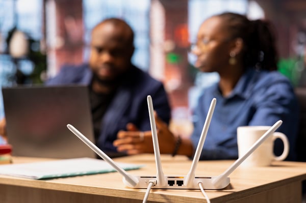 This is an image of two people working and appearing to have internet connectivity issues