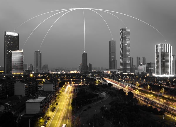 This is an image of a city with lights connecting the buildings.
