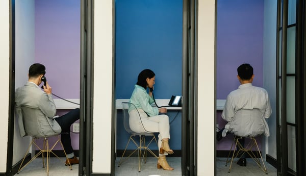 This is an image of people talking on office landlines.