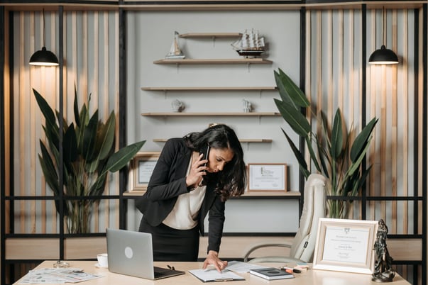 This is an image of a woman on the phone in an office.