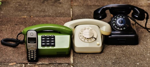 This is an image of an old phone and some landlines.