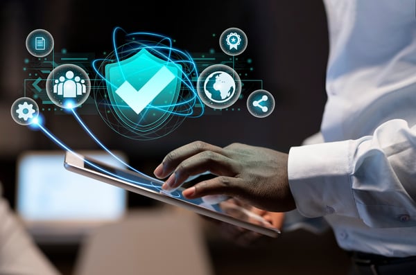 This is an image of a man navigating a cyber security interface on his tablet.