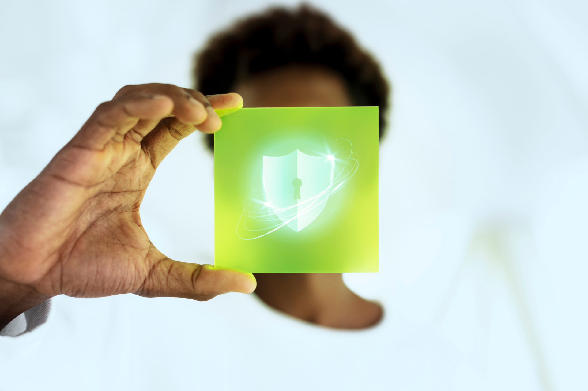 This is an image of a woman holding a cyber security badge.