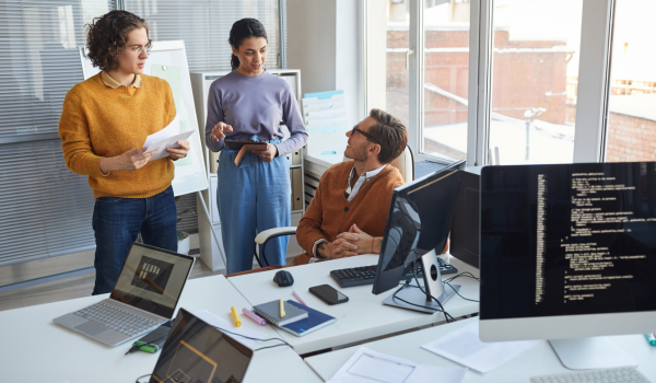 This is an image of people talking to each other in an office.
