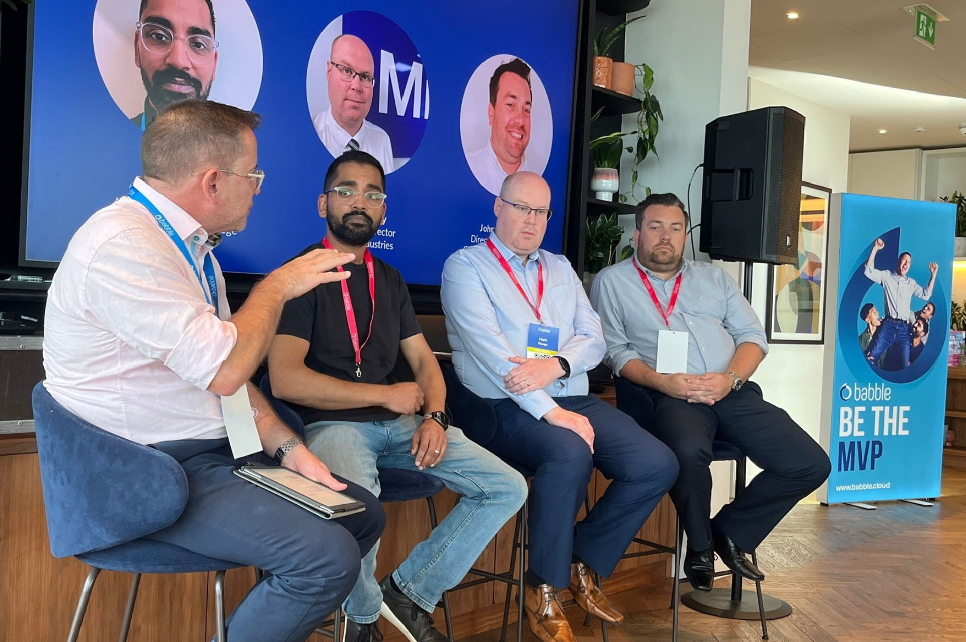 This is an image of our CMO having a panel discussion with three of our customers