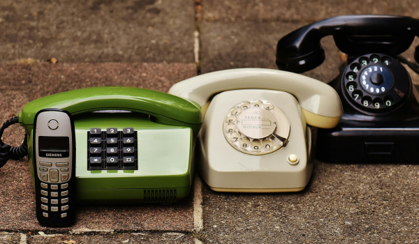 This is an image of an old phone and some landlines.
