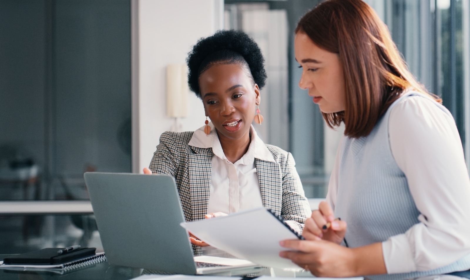 This is an image of two women looking at a laptop screen