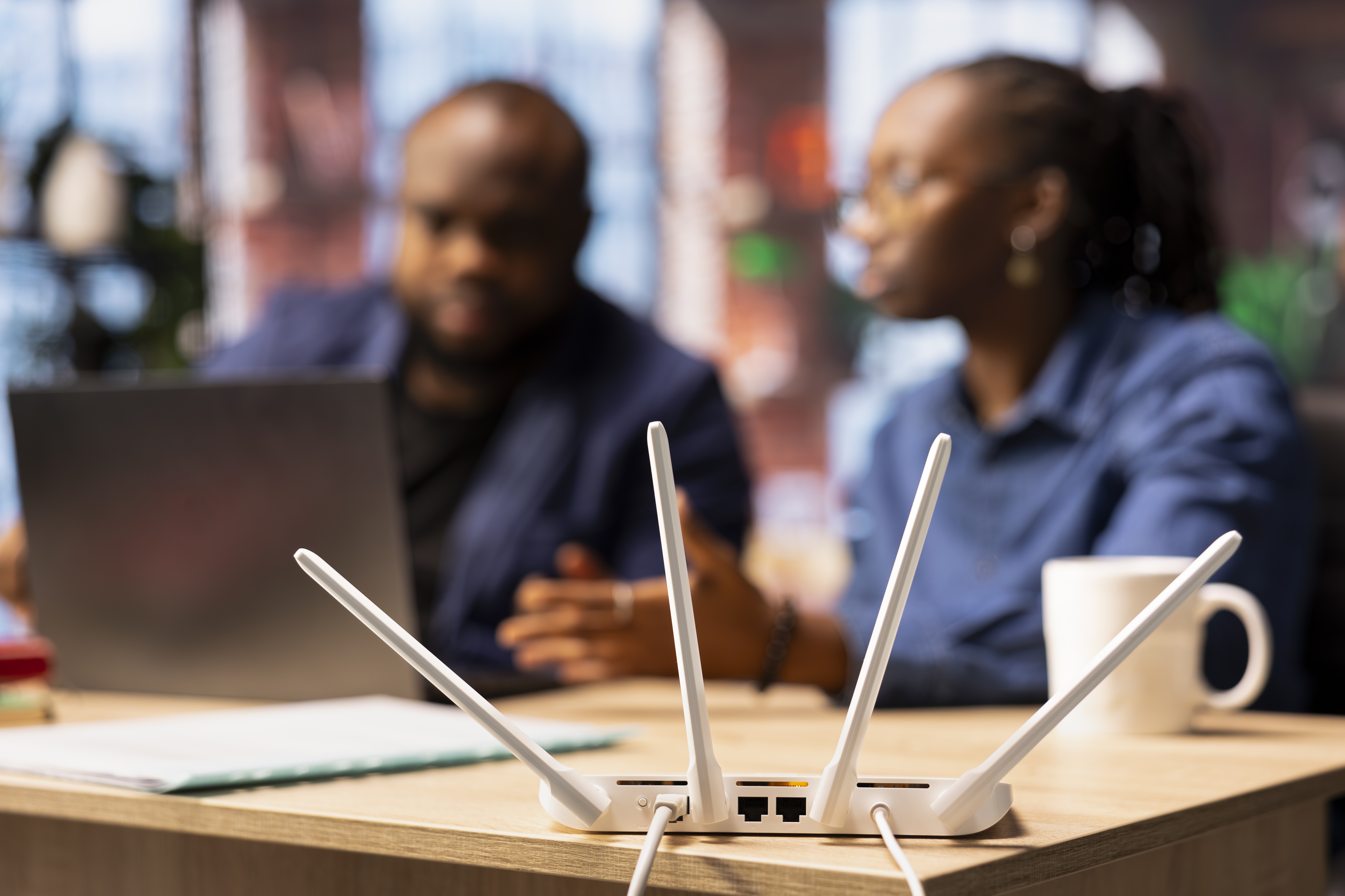 This is an image of two people working and appearing to have internet connectivity issues