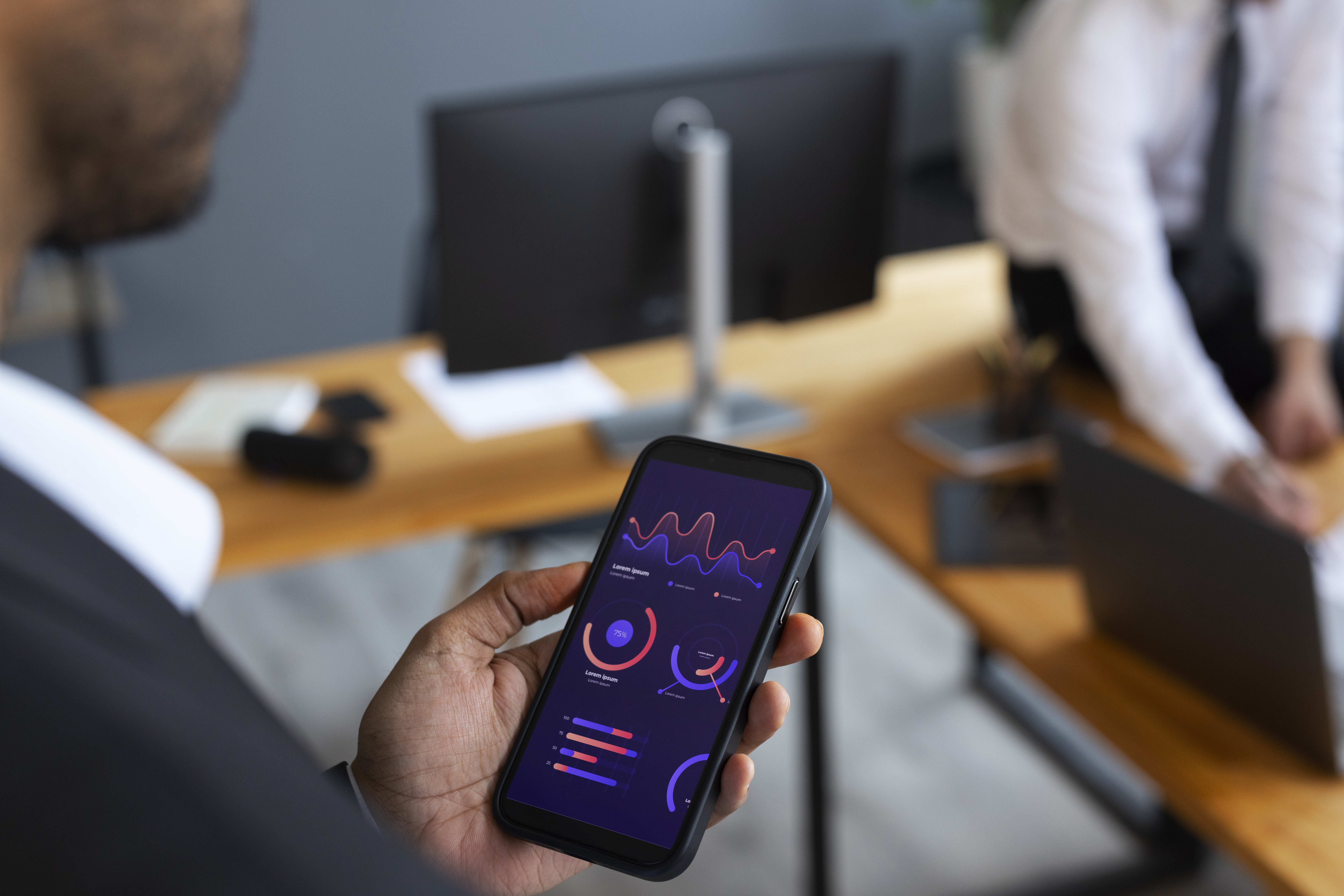 This is an image of a man looking at some financial data on a mobile phone.