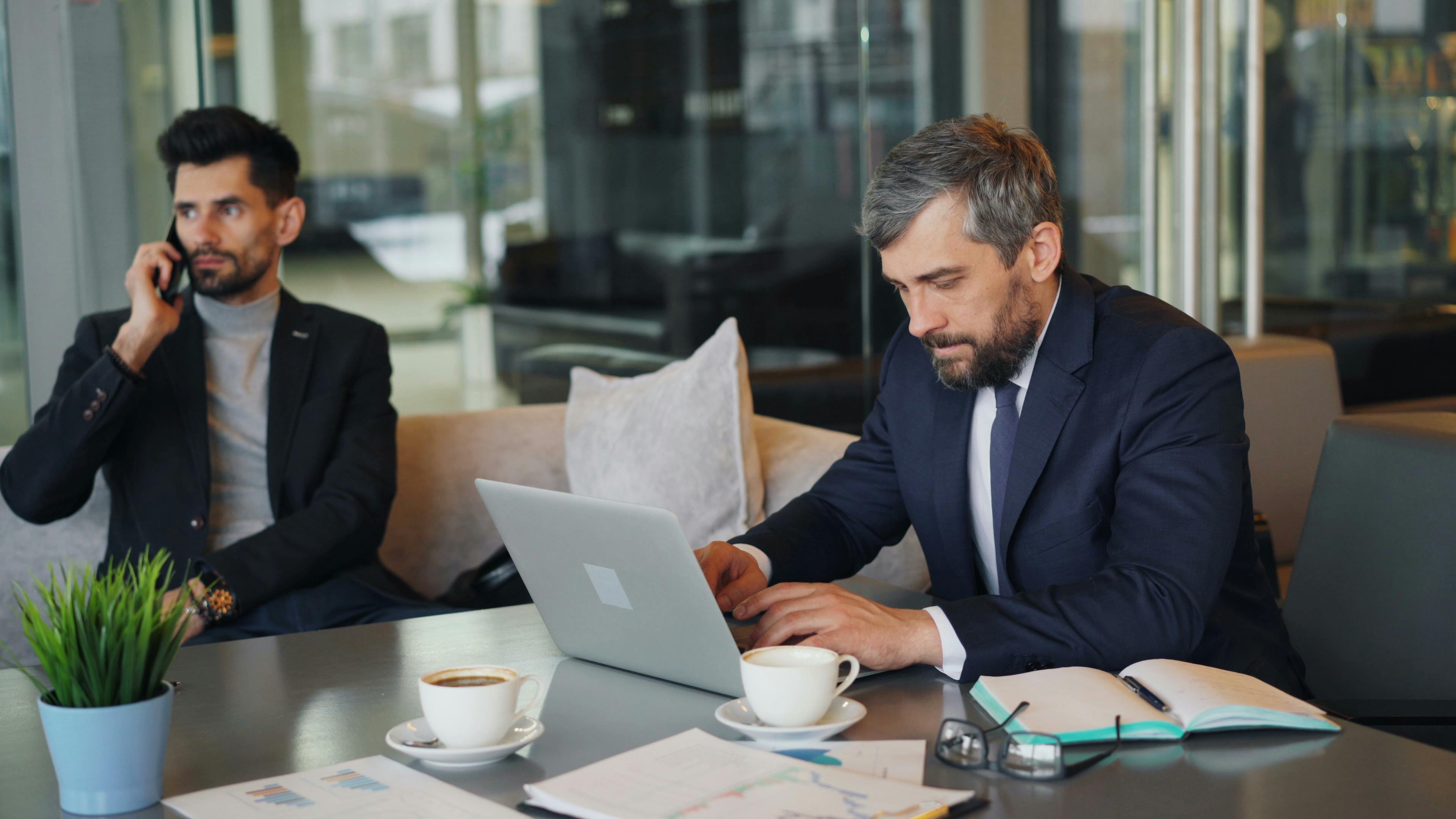 This is an image of two men having a working lunch.