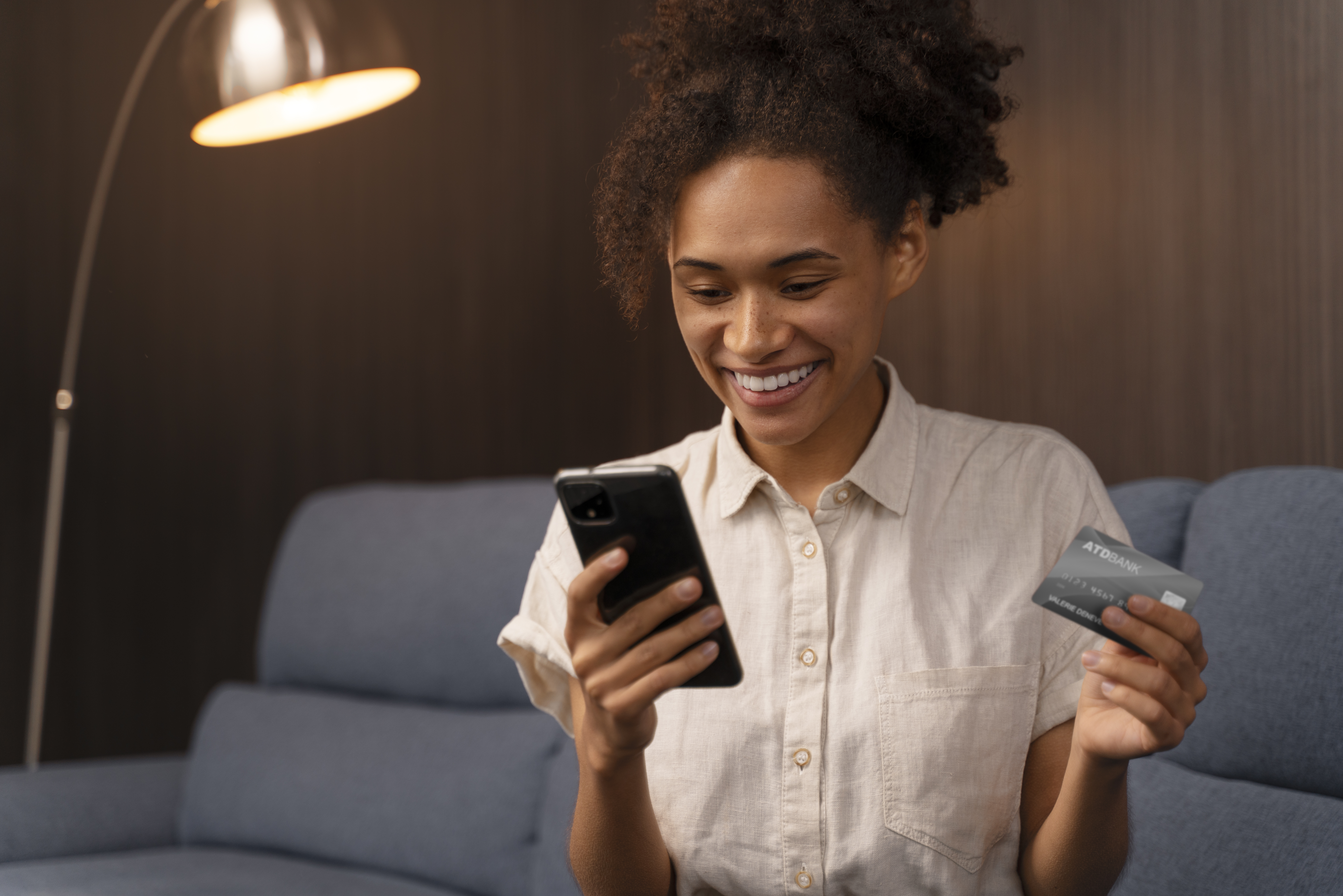 This is an image of a woman making a card payment over the phone.